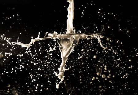 Spray of milk on black