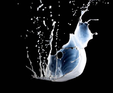 Spray of milk on blackの写真素材