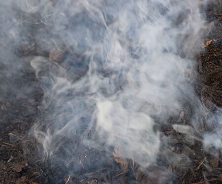 gray smoke when burning grassの写真素材