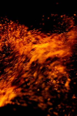 flame of fire with sparks on a black backgroundの写真素材