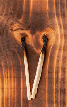 burnt match on wooden backgroundの写真素材