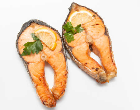 baked salmon steaks on a white backgroundの写真素材
