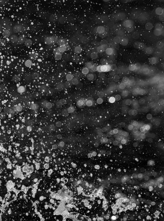 drops and splashes of water on a black backgroundの写真素材