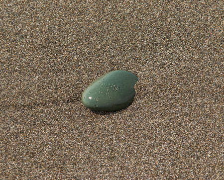 flat stone in the sand as backgroundの写真素材
