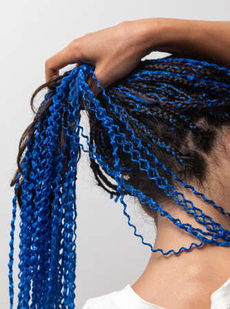 blue ribbons woven into the hair on a woman's headの写真素材