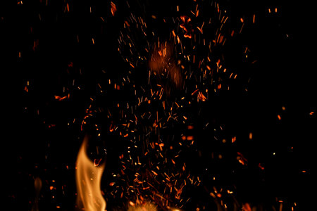 flame of fire with sparks on a black backgroundの写真素材