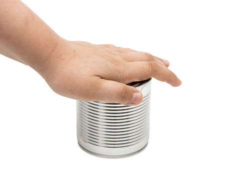 childrens hands open a tin can on a white backgroundの写真素材