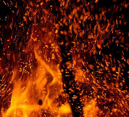 fire flame with sparks on black backgroundの写真素材