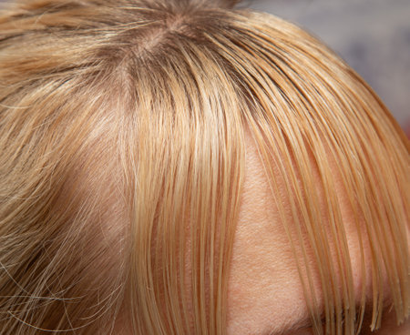 cutting long women's hair on the foreheadの写真素材