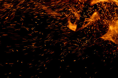 fire flame with sparks on black backgroundの写真素材