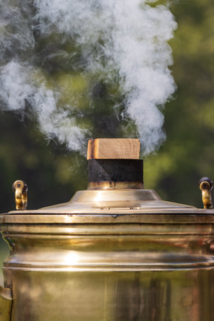 wood burning samovar in nature with smoke