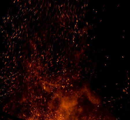 fire flame with sparks on black background.の写真素材