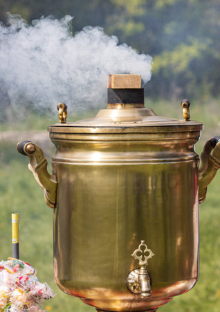 wood burning samovar in nature with smokeの写真素材