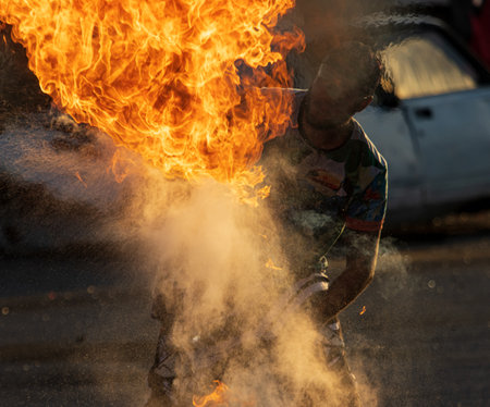 man blowing flames of fire as a background