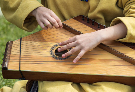 female hands playing a wooden musical instrument