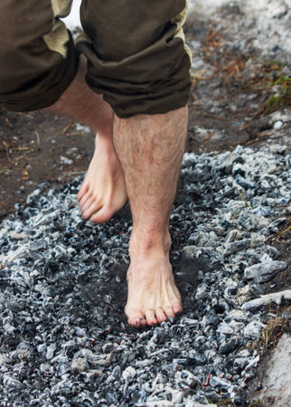 people walk with their feet on hot coals as a backgroundの写真素材