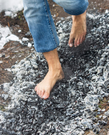 people walk with their feet on hot coals as a backgroundの写真素材