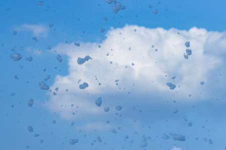 The sky is blue with a few clouds. The clouds are white and fluffy. The sky is clear and bright