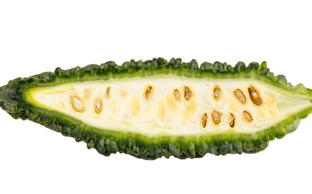 A green vegetable with a hole in the middle. The hole is surrounded by a green stem. The vegetable is sliced in half, revealing the seeds insideの写真素材