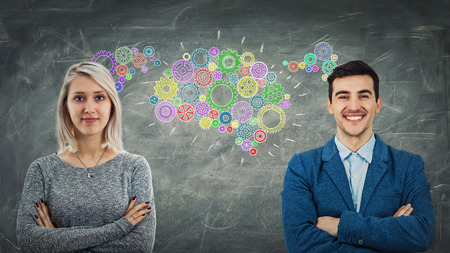 Man and woman sharing thoughts together as colorful cogwheels forming a common gear brain. Employee ideas exchange, business relationship and teamwork innovation concept.の写真素材