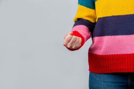 Angry young woman holding fist.Clouse up of a young student irritated and holding fist to camera.Self defence concept.の写真素材