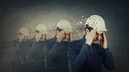 Engineer holding arms to head feeling exhausted. Headache and health problems. Conscience broken...