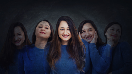 Young woman suffer split emotions into five different inner personalities. Multipolar mental health disorder concept. Schizophrenia psychiatric disease. Face expressions and reactions mood change.の写真素材