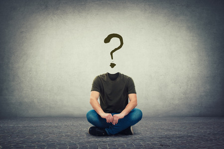 Surreal headless guy, invisible face seated on the floor with a question mark instead of head, like a mask, for hiding identity. Interrogation sign symbolizing anonymity. Uncertainty concept.の写真素材