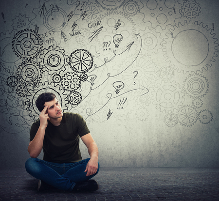 Man sitting on the floor hard thinking, find a solution to solve problem. Different imagination,...