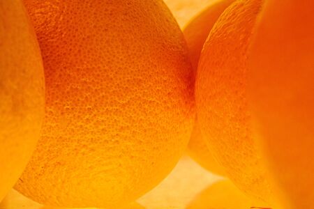Fresh orange fruit isolated on white background. Close-up of  fresh orange peel over yellow...