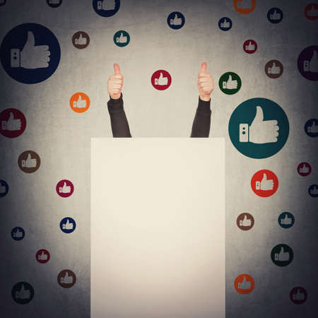 Contented person hidden behind a blank whiteboard, hands outstretched up, showing both thumbs up...