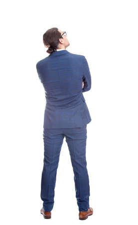 Rear view businessman in suit looking up thoughtful, full length portrait isolated on white background. Business planning conceptの写真素材