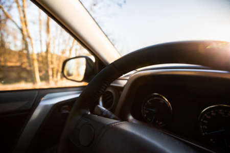 Car steering wheel interior at sunrise. Traveling with car concept. car insurance conceptの写真素材
