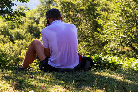 Sweat man in the forest speaking by phone.の写真素材