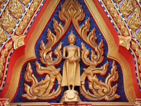 Golden Buddha and angel on gable chapelの写真素材