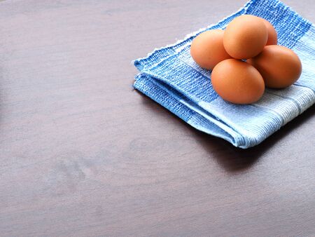 boiled eggs was placed on the blue tablecloth on the tableの写真素材
