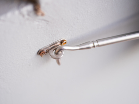 silver window or door hook latch on the white wallの写真素材