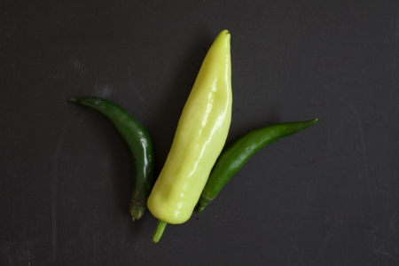 Green Sweet Pepper arrange like a corn on Black Chopping Blockの写真素材