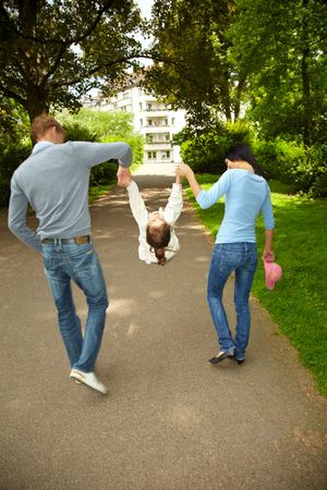 Parents let her daughter swingの写真素材