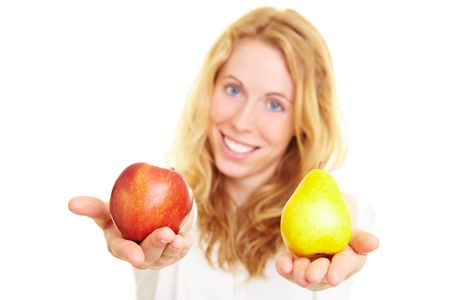 Blonde woman holding an apple with a pearの写真素材