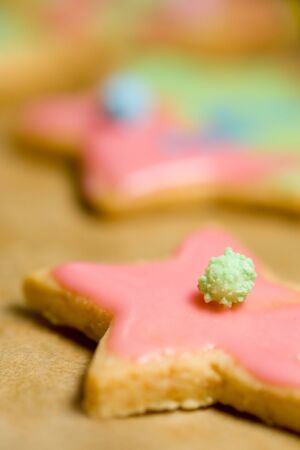 Colorful cookies with icing on a baking sheet