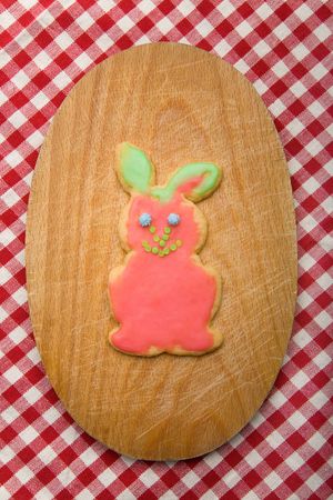 Colorful easter bunny on a board on a tablecloth