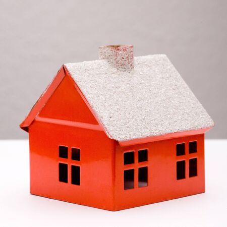 Little red house with chimney and windowsの写真素材