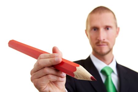 Manager writing with an oversized red pencilの写真素材