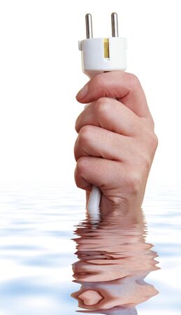 Hand with power plug reaching out of waterの写真素材