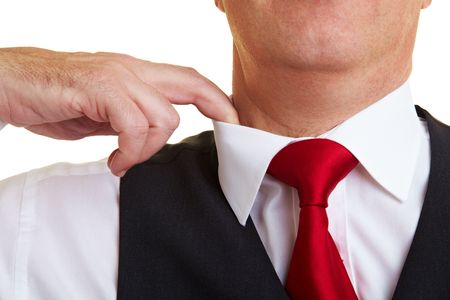 Businessman lifting the collar with his fingerの写真素材