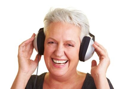 Happy senior woman listening to music with headphonesの写真素材
