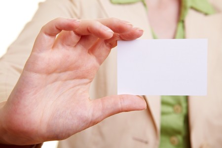 Businesswoman holding an empty white business cardの写真素材