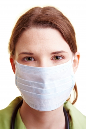Female doctor with a breathing mask over the mouthの写真素材