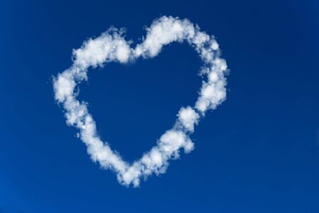 Heart made of clouds in a blue skyの写真素材